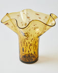 Brown glass vase with textured surface on a white background