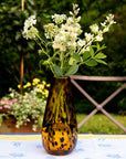 Decorative vase with flowers on a table outdoors
