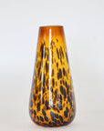A hand-blown, brown glass vase with a tortoise shell pattern design.