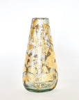 A hand-blown glass vase with 14k gold leaf detailing, with a focus on the texture and shine of the gold against the clear glass.