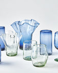 Collection of blue and clear glassware on a white background
