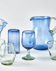 Collection of blue and clear glassware on a white background