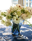 Blue glass vase with a wavy pattern with flowers