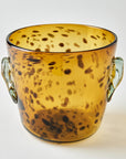 Speckled amber glass vase with handles on a white background