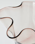 Glass vase with wavy design on a white background