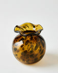 Glass vase with a tortoise shell design on a white background