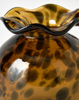 Brown glass vase with wavy rim on a white background