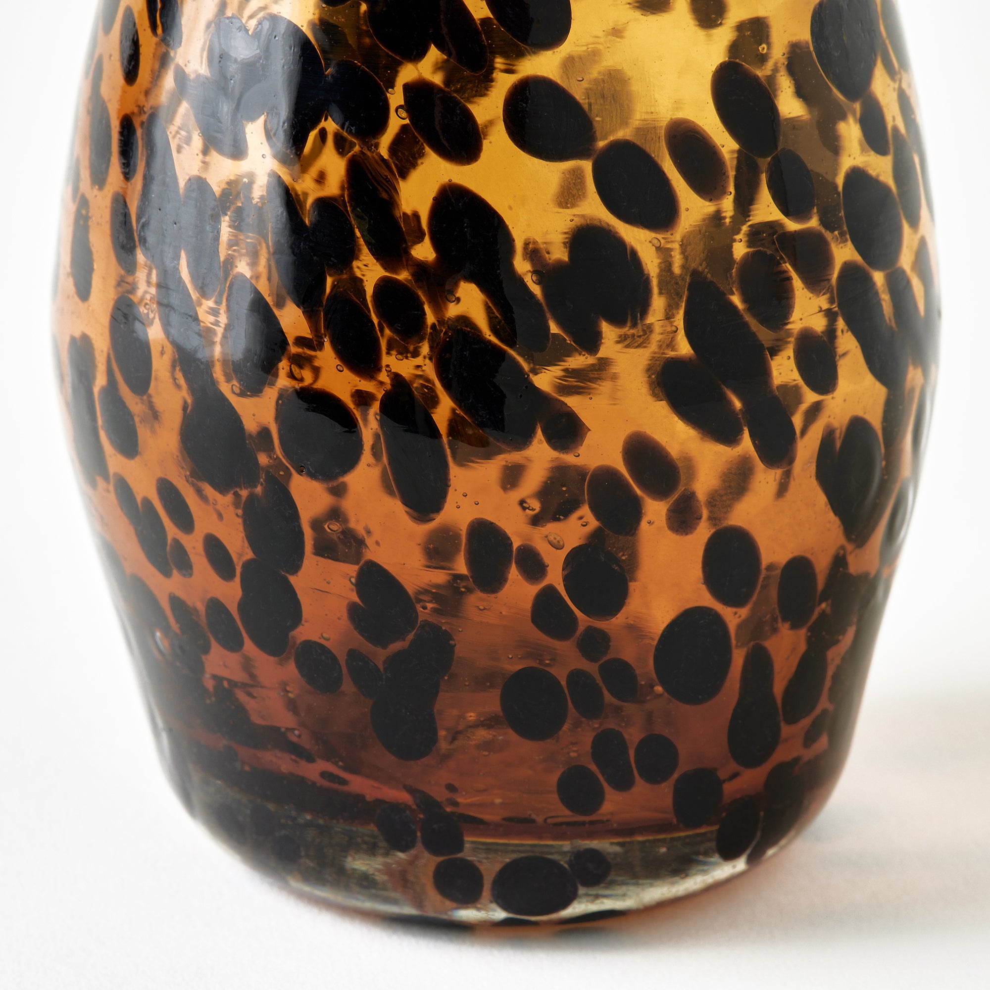 Glass with tortoise print pattern on a white background