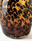 Glass with tortoise print pattern on a white background