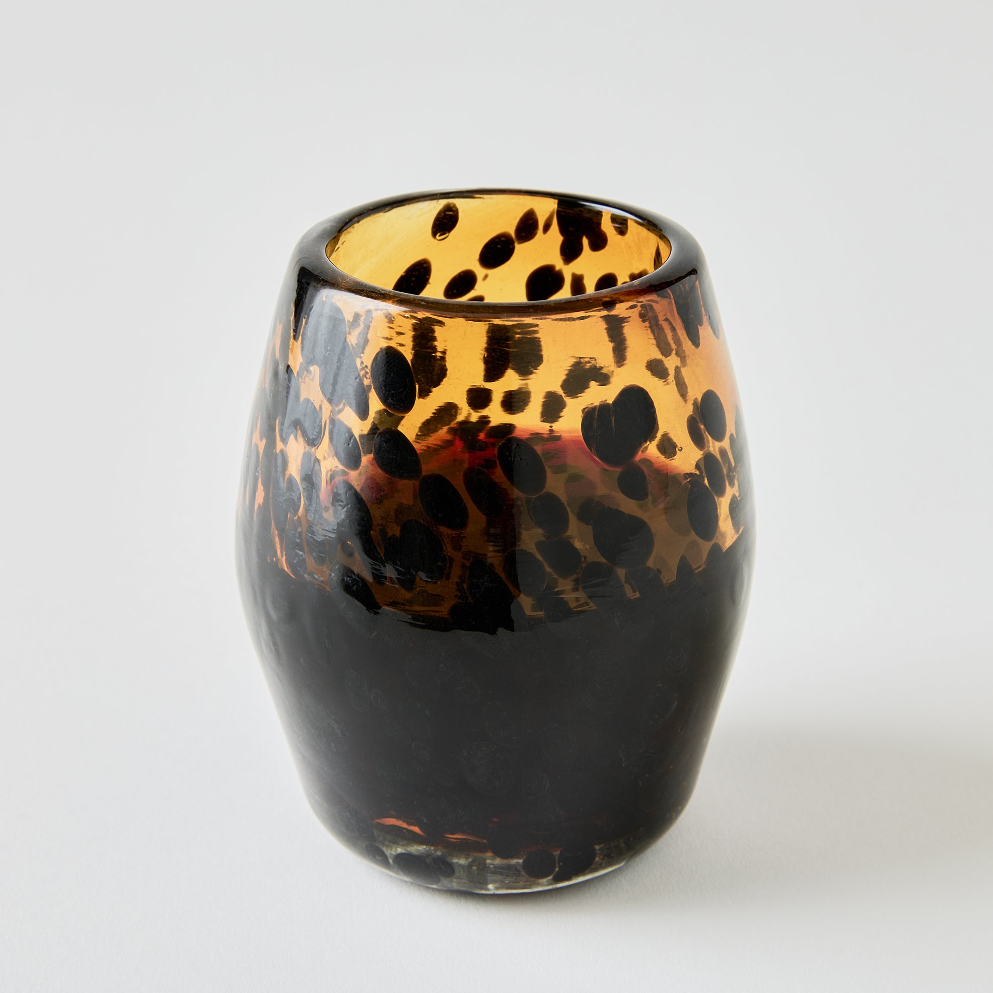 Tortoiseshell-patterned glass on a white background
