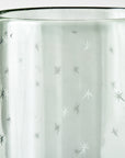 Clear glass candlelight holder with star pattern on a white background