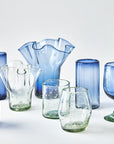 Collection of blue and clear glassware on a white background