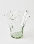Clear glass vase with wavy design on a white background
