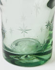 Decorative glass with star etching on a white background