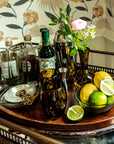 Bar cart with drinks and garnishes on a decorative wall background