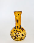 A hand-blown, brown glass vase with a tortoise shell pattern