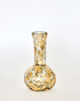 Decorative glass vase with gold speckles on a white background
