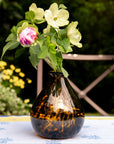 Decorative vase with flowers on a table outdoors