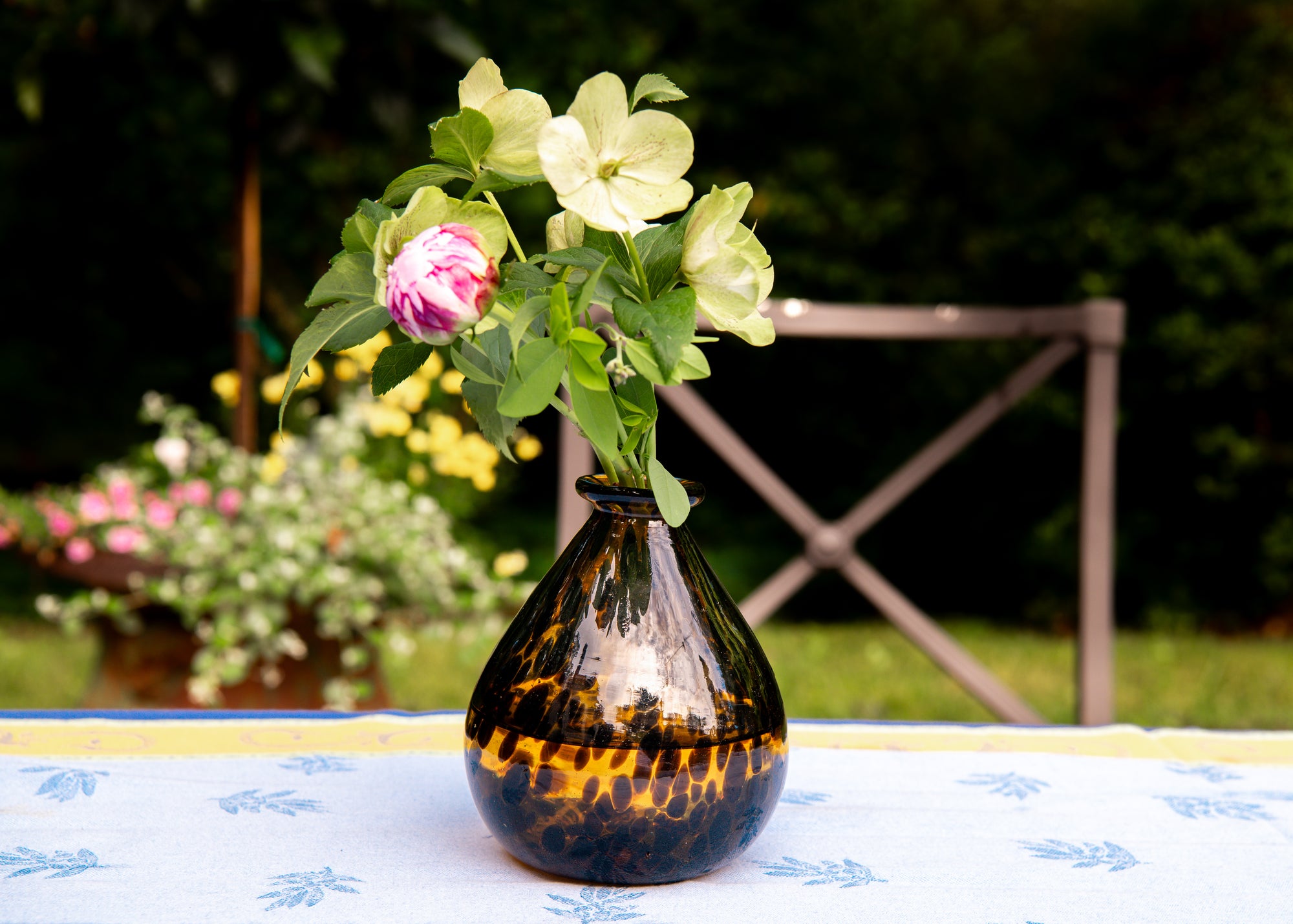 Decorative vase with flowers on a table outdoors