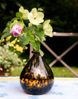 Decorative vase with flowers on a table outdoors