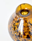 Tortoiseshell patterned glass vase on a white background