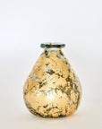 A hand-blown, gold leaf decorative glass vase with a teardrop shape on a white background.