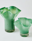 Two green glass vases on a white background
