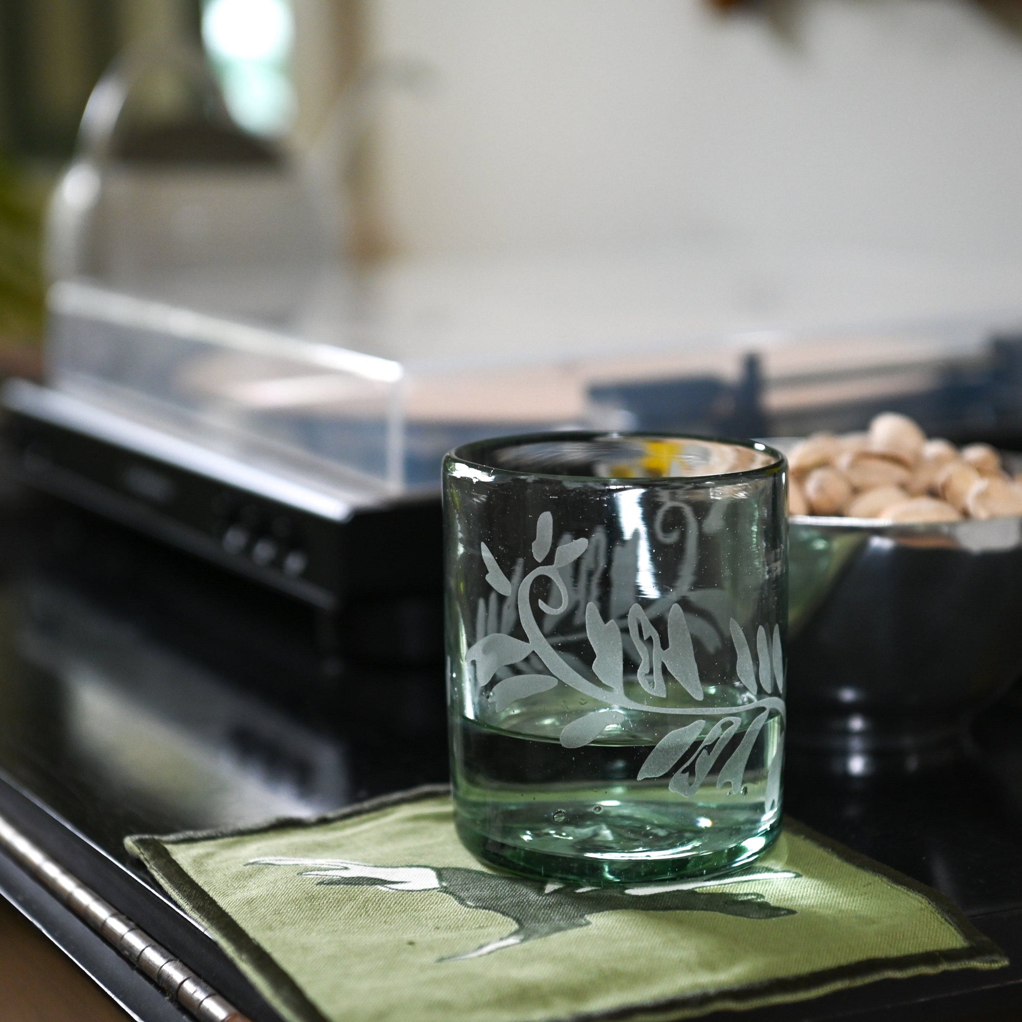 Decorative rocks glass on a kitchen counter with a blurred background