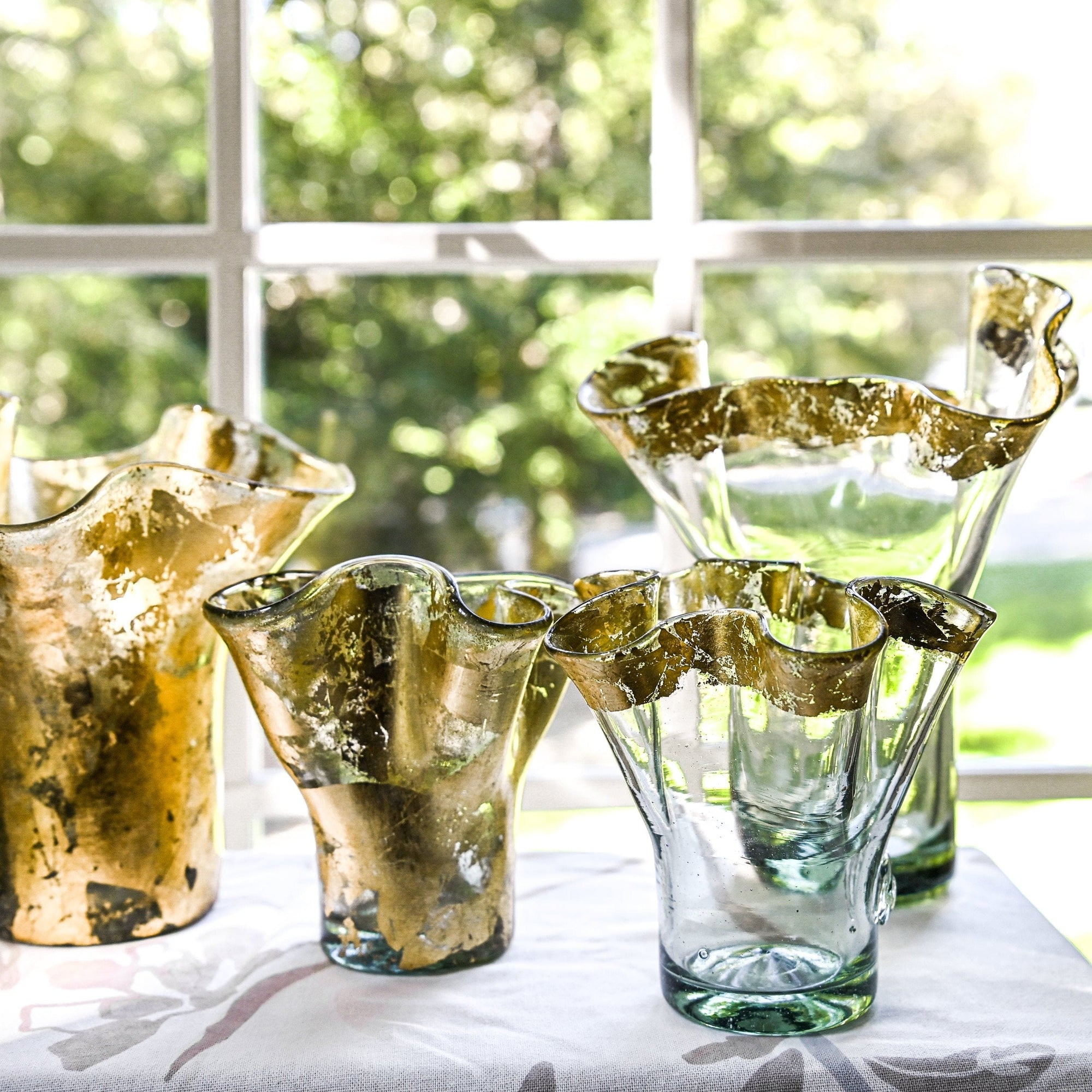 Clear vases with hand-applied 14k gold leaf at the rim