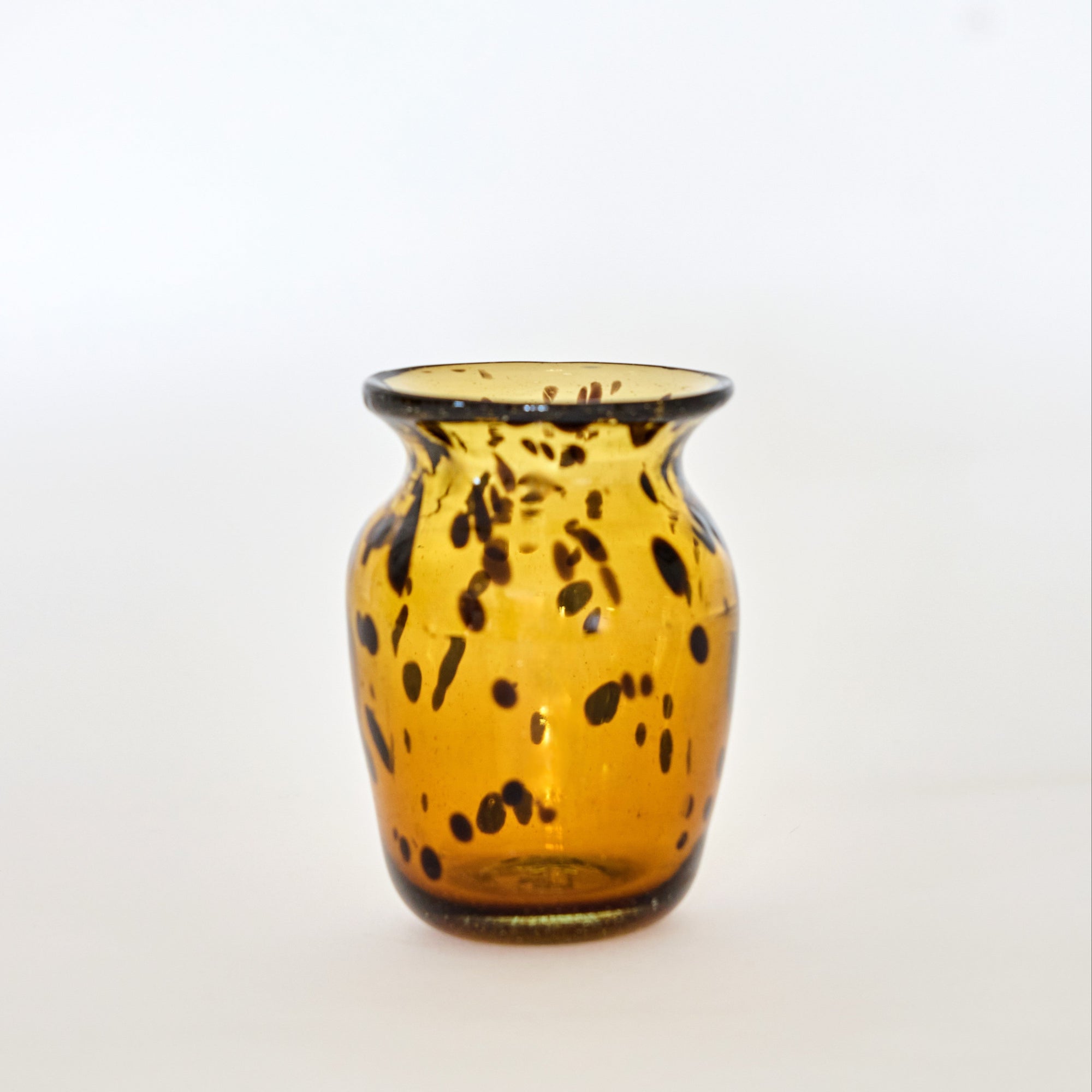 A brown glass vase with a tortoise shell pattern design.