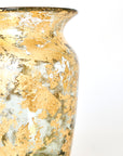 Glass vase with gold leaf on a white background