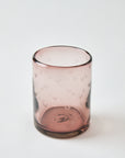 Pink glass with textured surface on a white background