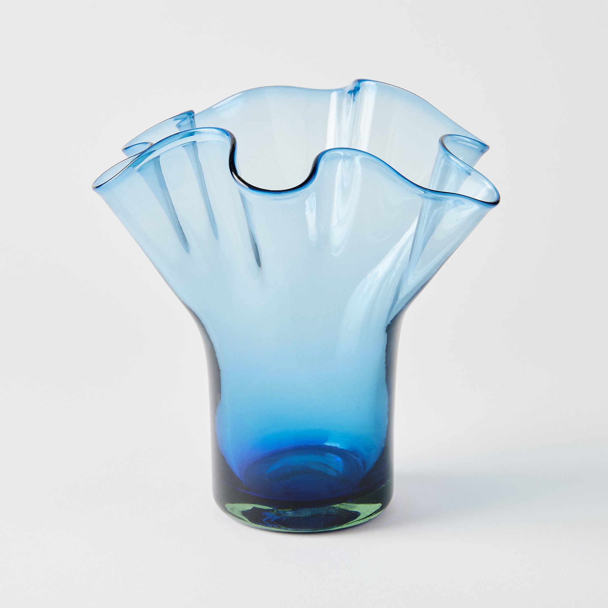 Blue glass vase with a unique design on a white background