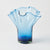 Blue glass vase with a unique design on a white background