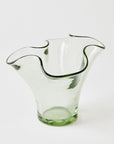 Clear glass vase with wavy design on a white background
