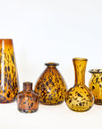 A collection of hand-blown glass vases in a brown tortoise pattern with various sizes and shapes displayed against a white background.
