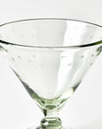 Clear footed dish glass with star patterns on a white background
