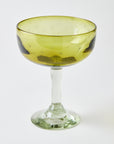 Yellow margarita glass with clear stem, etched with stars, on a white background