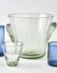 Clear glass ice bucket with handles and blue glass tumblers on a white background