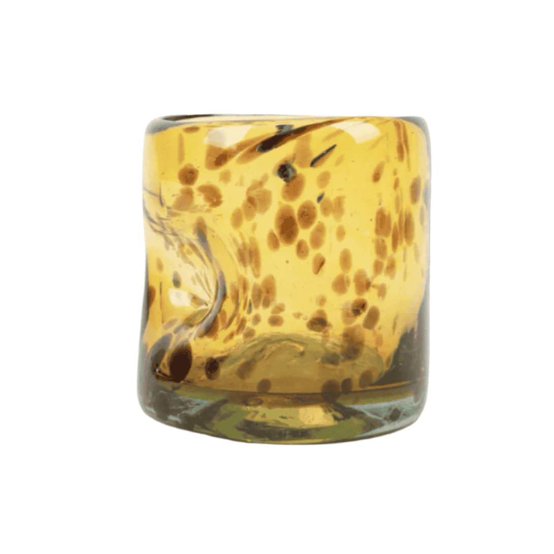 Brown spotted glass with a thumbprint indent on a white background