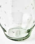 Clear glass tumbler with star patterns on a white background