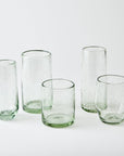 Set of five clear glass tumblers on a white background