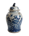 Blue and white ceramic jar with floral patterns on a white background
