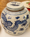 White ceramic jar with blue dragon design on a white surface