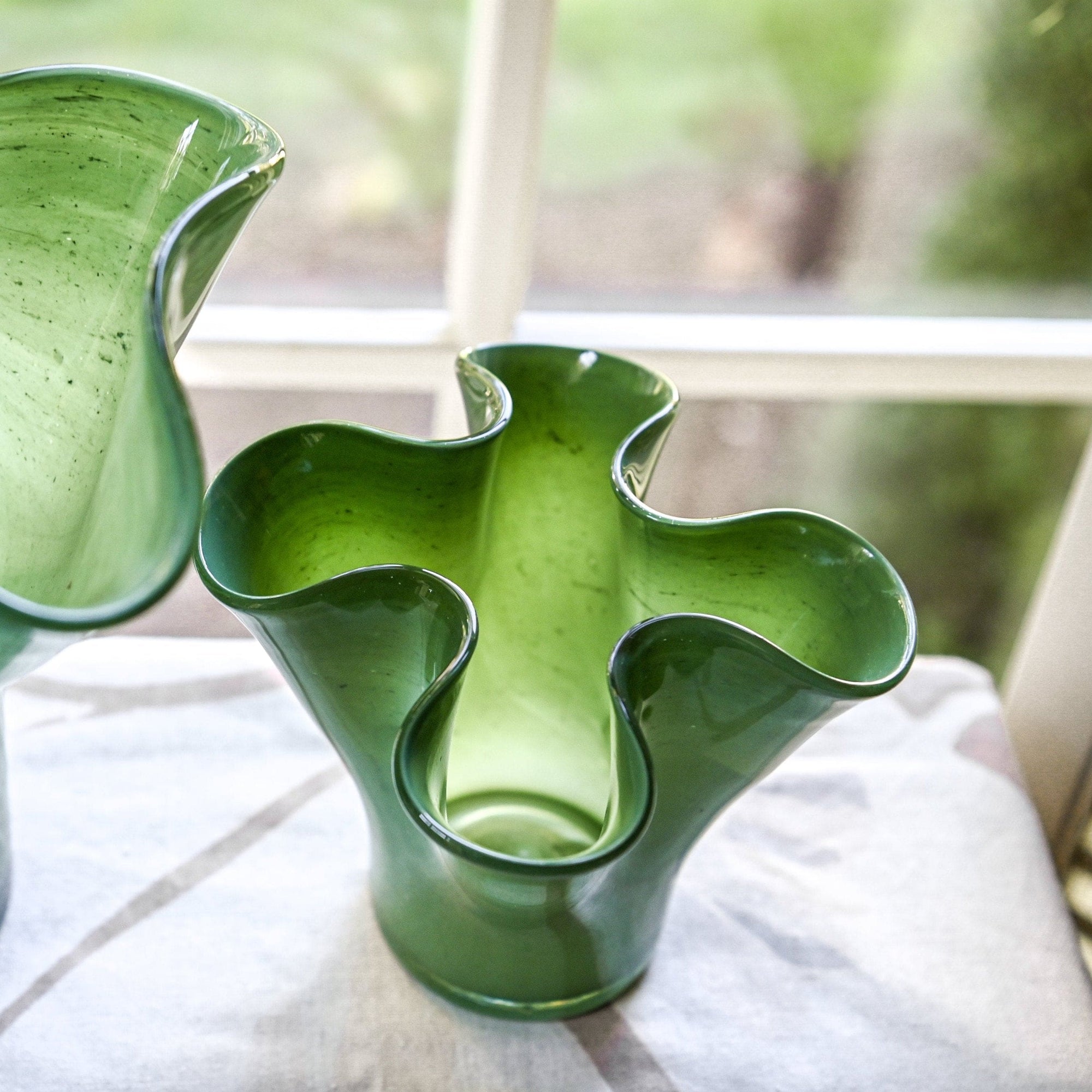 Top view of a green glass vase shaped like a lettuce leaf