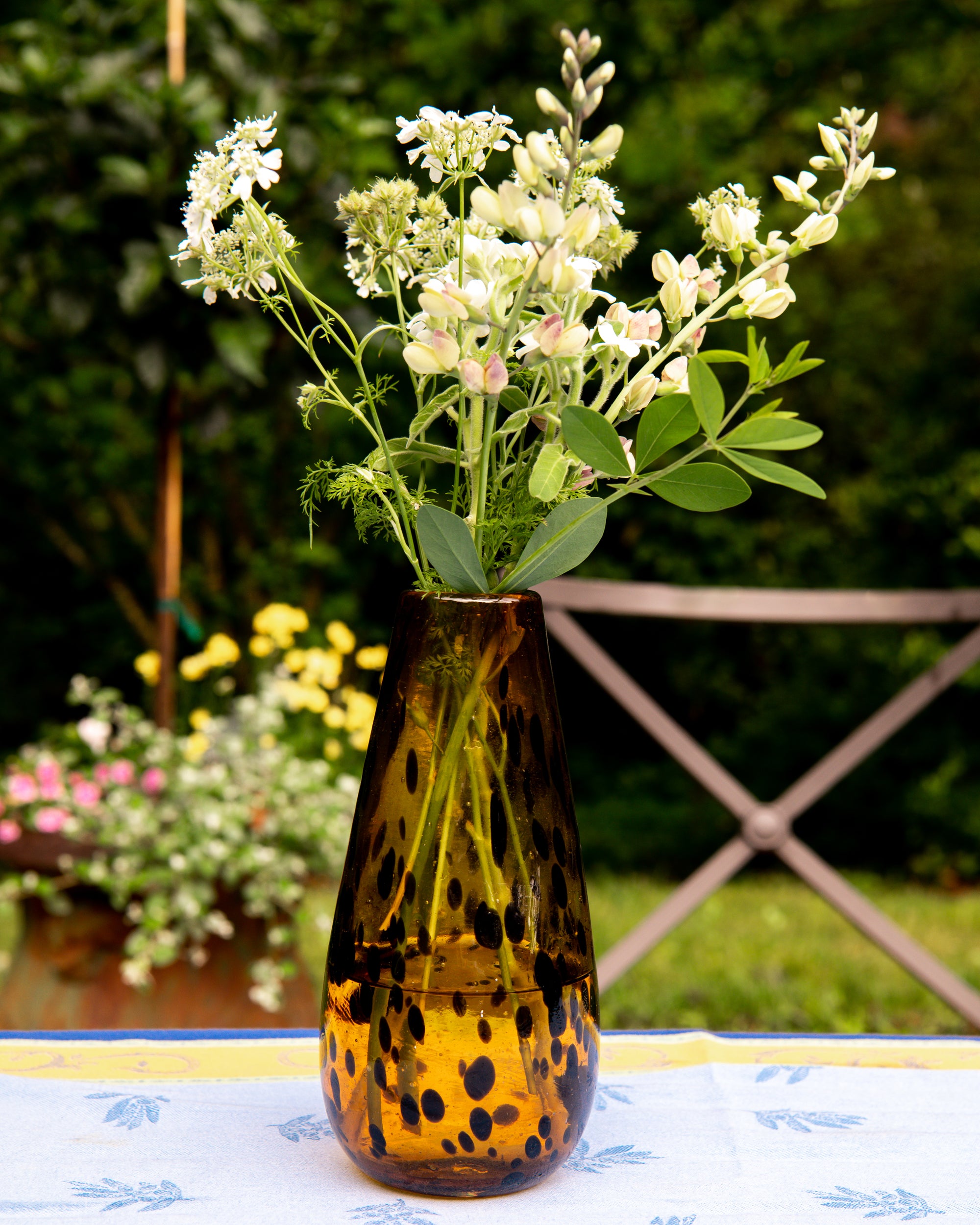 Decorative vase with flowers on a table outdoors