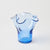 Blue glass vase with wavy design on a light gray background