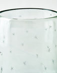 Close up shot of a clear glass candlelight holder with star pattern on a white background