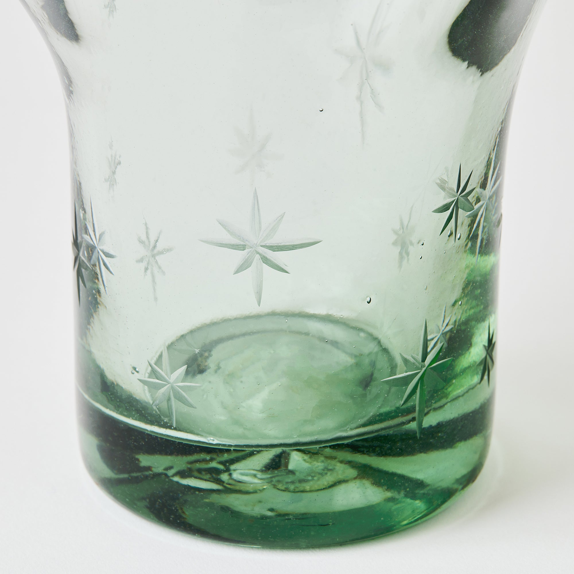 Decorative glass with star etching on a white background
