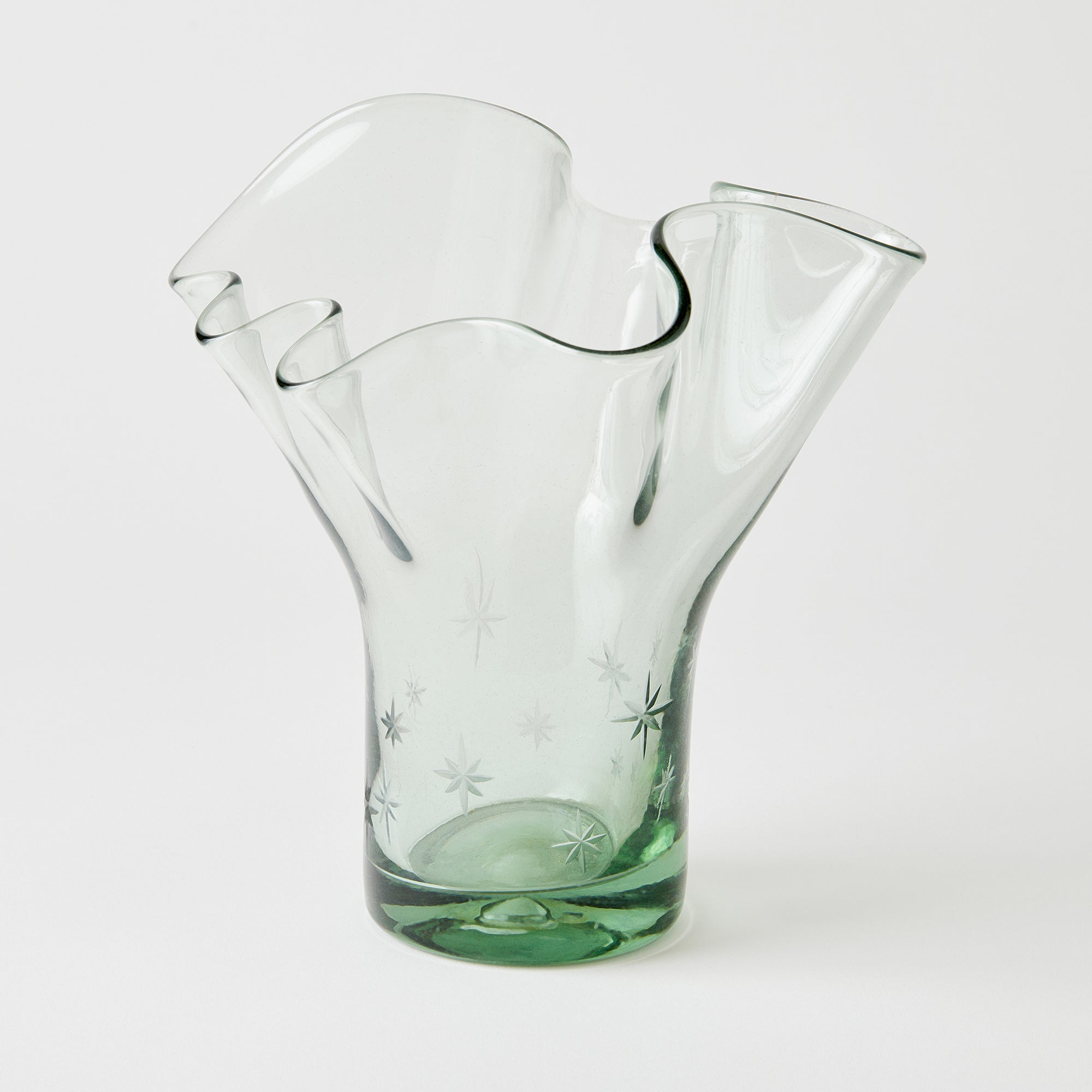 Glass vase with a unique star design on a white background